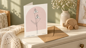 Personalised birth flower greeting card with a blush arch in a nursery keepsake setting