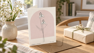 Personalised birth flower greeting card with a blush arch in a gift table setting
